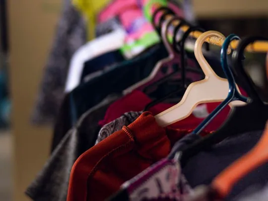 Garments hanging on a rail in a clothing shop