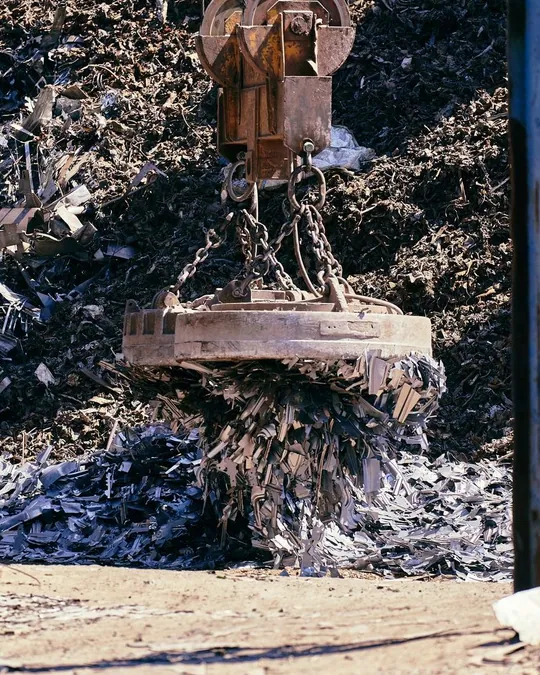 Magnet lifting metal scrap in a recycling yard